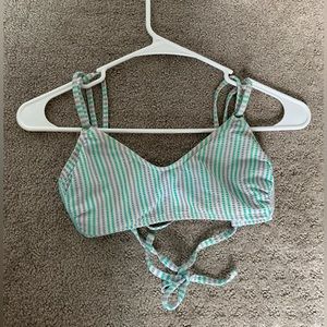 Bikini top, ribbed and striped, a little dirty from lake, too small for me now